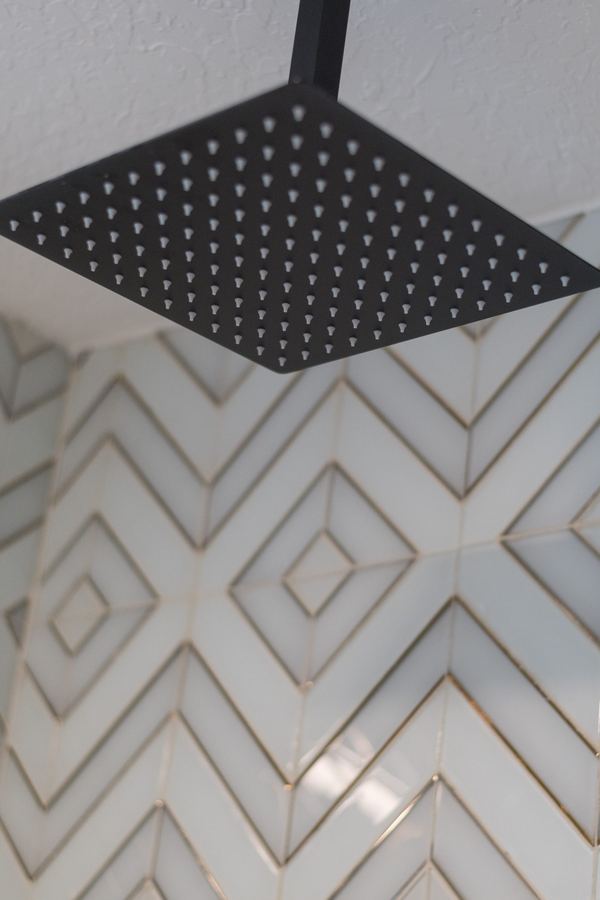 Master shower with geometric tile and rainfall showerhead