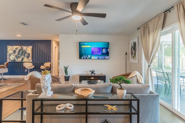 Living room with smart TV and view to screened porch
