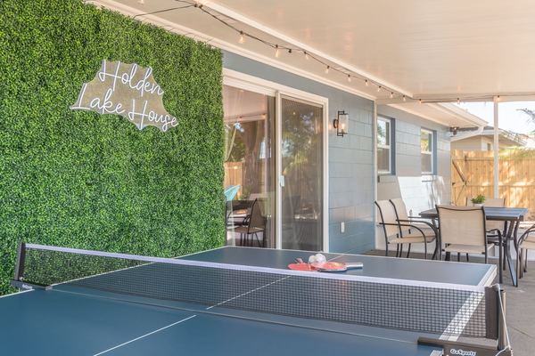 Ping pong table with Holden Lake House neon sign